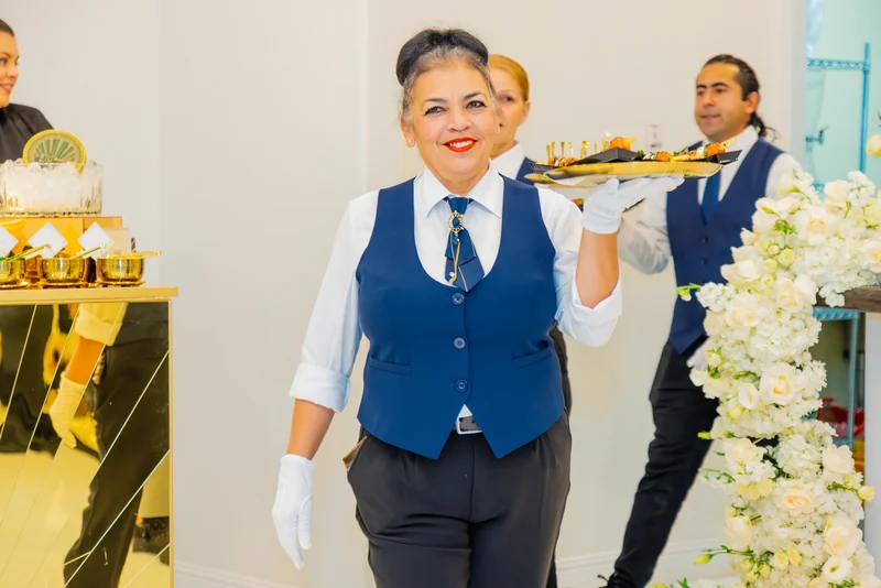 Servers passing trays during service